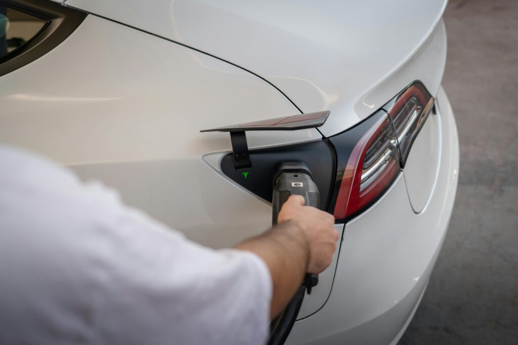 Close-up of an electric car being charged, emphasizing modern sustainable technology.